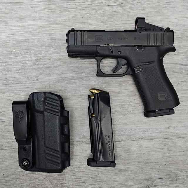 Glock 43x with a red dot and 2 mags